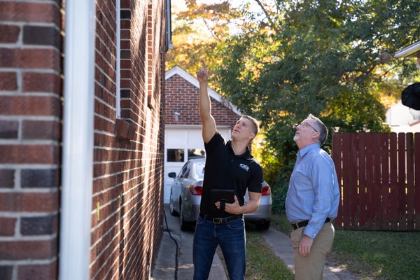 JES Foundation Repair inspector and homeowner inspecting house