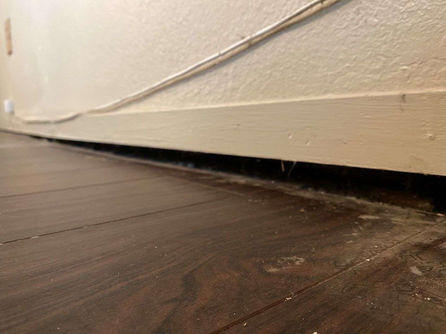 uneven floor with a gap between the floor and wall