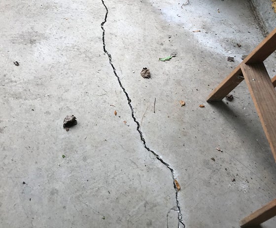 Close up of a floor crack in a garage.
