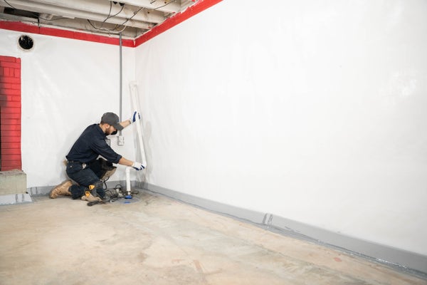JES inspector installing basement waterproofing