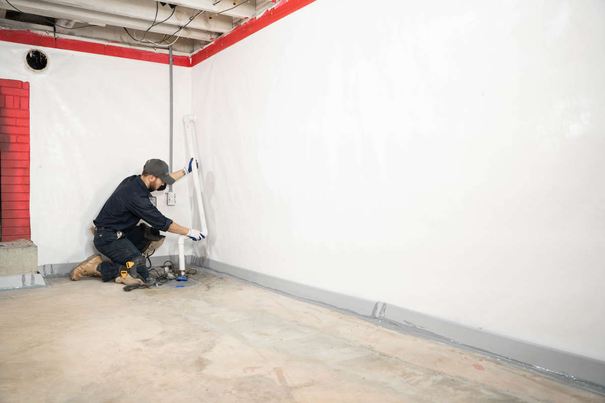 JES inspector installing basement waterproofing