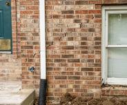 Exterior brick wall with cracks.