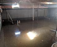 Interior of flooded basement with sun