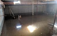 Interior of flooded basement with sun