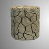 A cracked, clay-like cylindrical sculpture with a fragmented surface on a gray background.