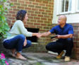 IBA's CFI and the homeowner are shaking hands outside of the crawlspace.