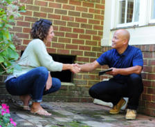 IBA's CFI and the homeowner are shaking hands outside of the crawlspace.