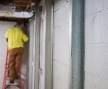crew member installing basement wall braces
