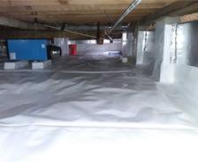 Vapor barrier and dehumidifier in crawlspace; wide shot.