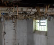 Open basement vents with wiring hanging from the ceiling.