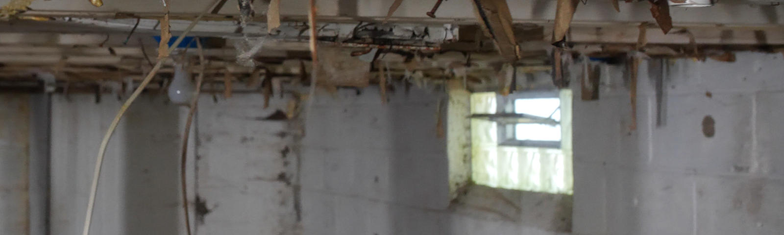 Open basement vents with wiring hanging from the ceiling.