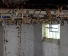 Open basement vents with wiring hanging from the ceiling.