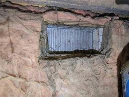 Vent cover surrounded by dirty insulation.