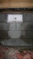 Mold and damp open crawlspace vent.