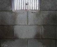Mold and damp open crawlspace vent.