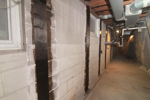 Carbon fiber installed on cinderblock wall.