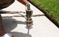 Crew injecting poly into a sidewalk.