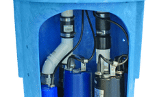 A blue sump pump system with visible pipes and components inside a circular container.