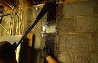 Crew installing carbon fiber basement wall repair
