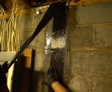 Crew installing carbon fiber basement wall repair