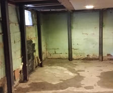 Interior bowing leaking walls and floors in the basement.