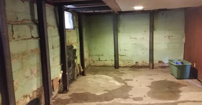 Interior bowing leaking walls and floors in the basement.