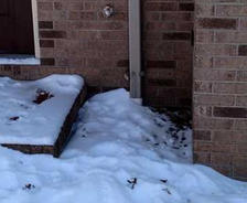 Snow covering downspout and drain.