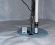 Close-up of vapor barrier and sump pump in crawlspace.