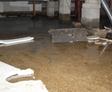 Flooding crawlspace with dirt and drywall over the floor.