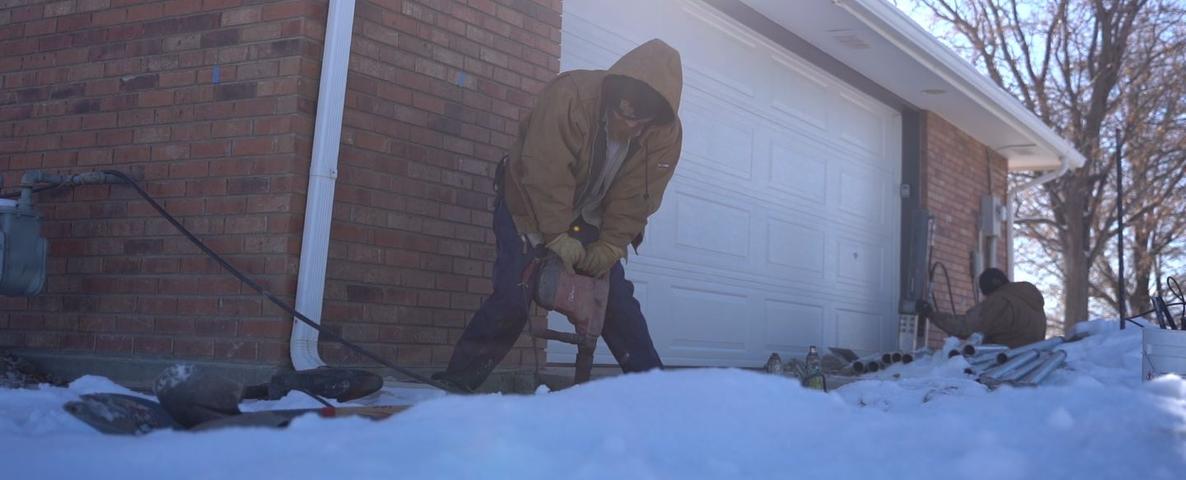 Crew drilling outside with snowy weather.