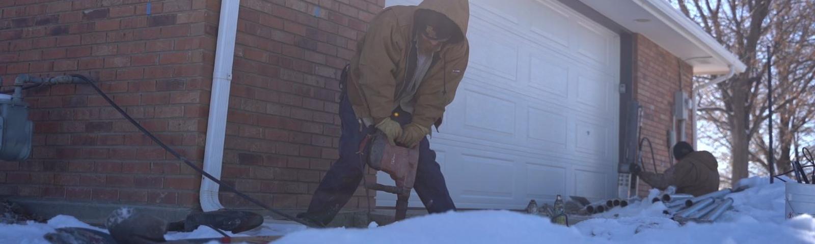 Crew drilling outside with snowy weather.