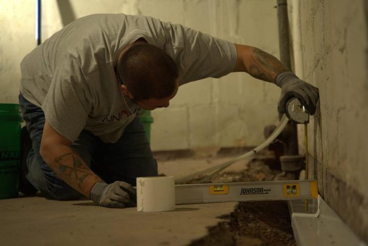 Crew installing basement gutter guards.