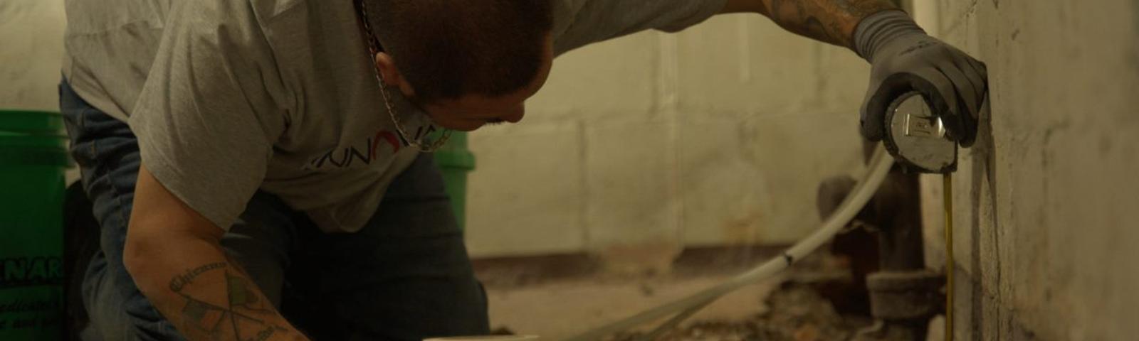 Crew installing basement gutter guards.
