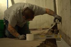 Crew installing basement gutter guards.