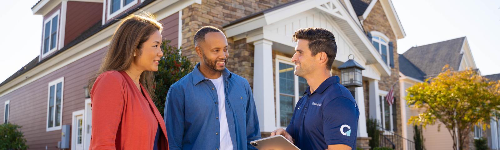 Innovative Basement Authority CFI with couple in front of house - desktop hero
