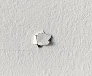 Nail pop on interior wall.