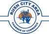 Logo with "Rush City Area Chamber of Commerce" text and a silhouette of plants against an orange sun.