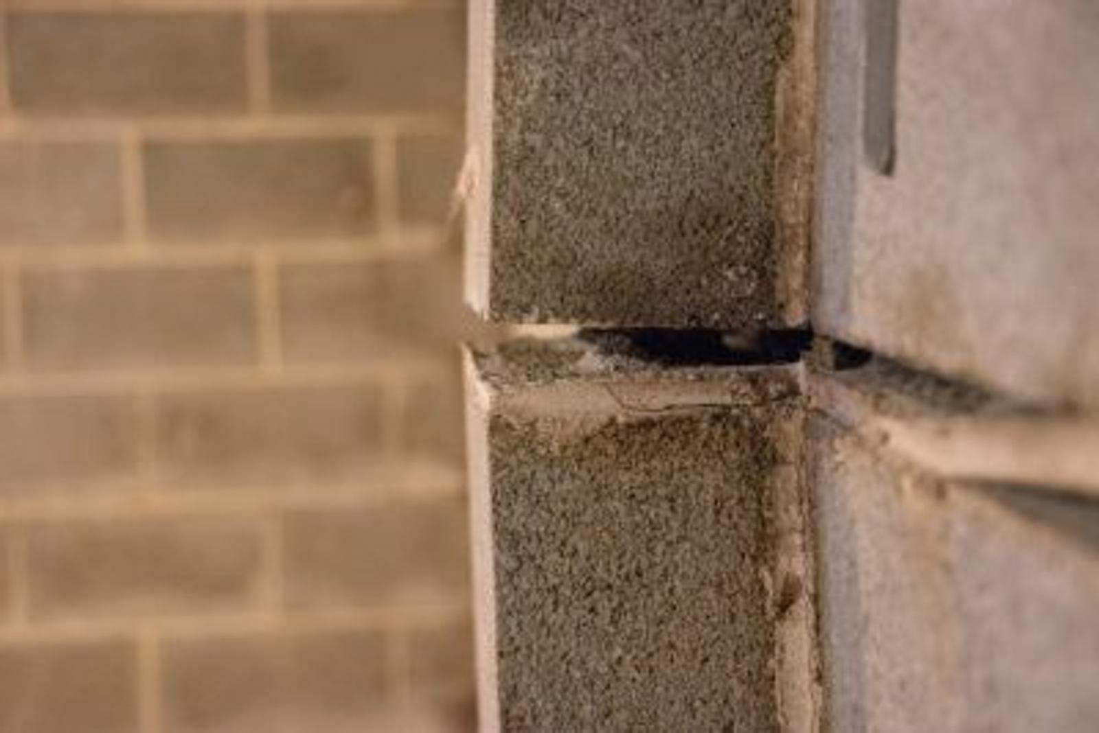 Cinderblock bowing wall with gap.