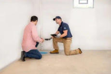 Groundworks Expert explains to home owner the solution installed in their basement