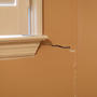 Lower vertical crack on the window wall.