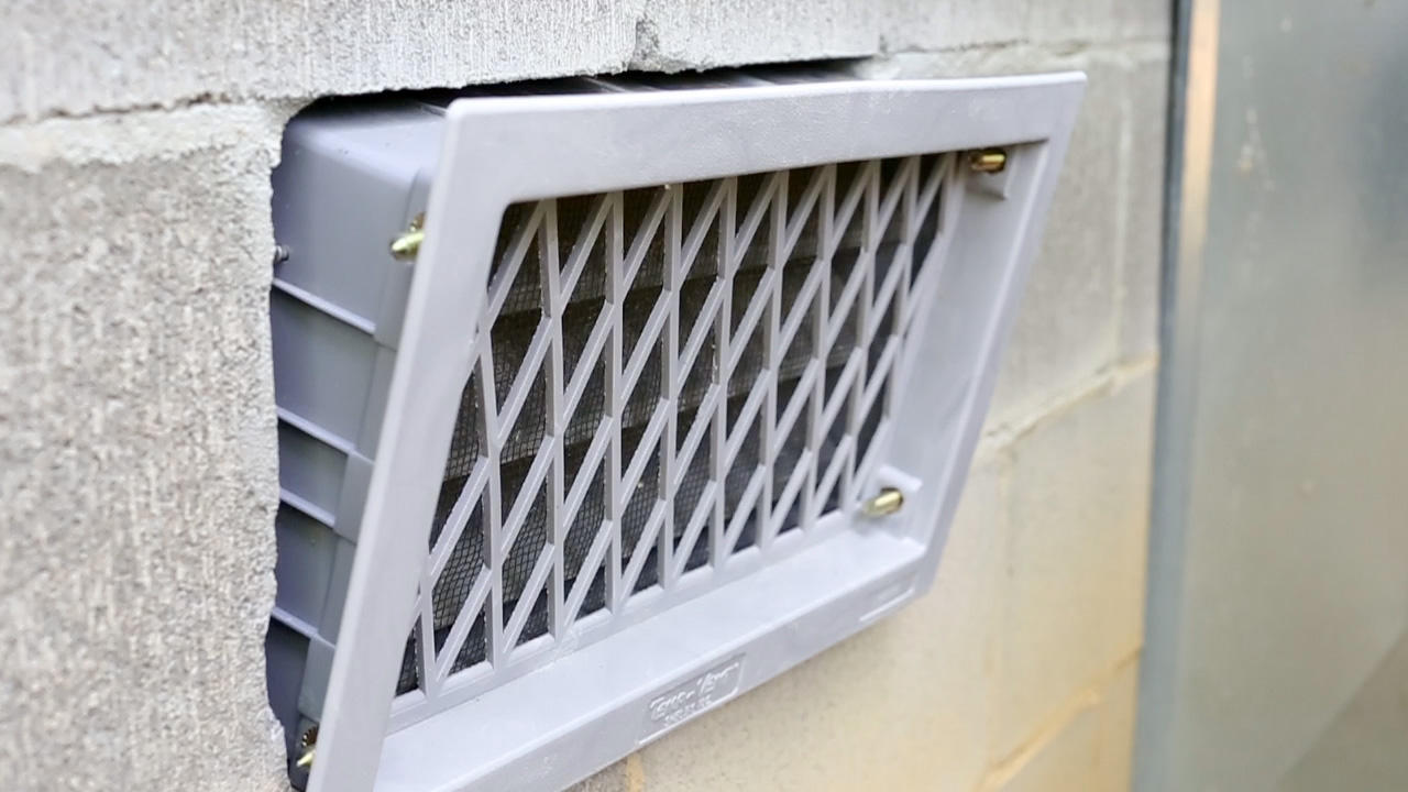 Close-up of open crawlspace vent.