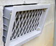Close-up of open crawlspace vent.