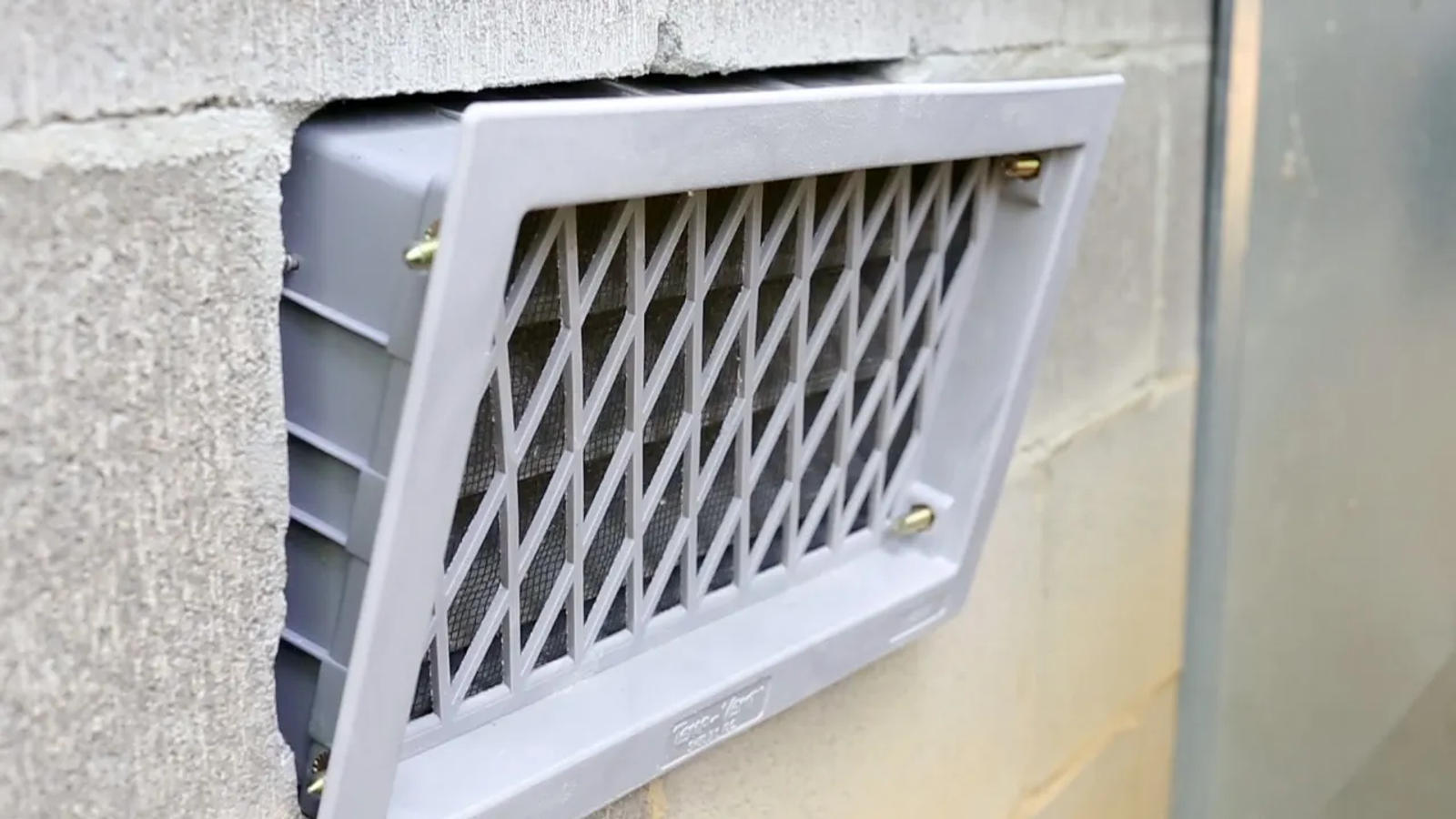 Close-up of open crawlspace vent.