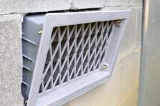 Close-up of open crawlspace vent.