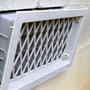 Close-up of open crawlspace vent.