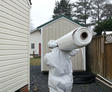 Crew carrying vapor barrier outside of the job site.
