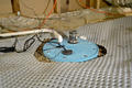 The top of the sump pump and drainage matting.