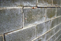 Cracks and bowing cinderblock foundation wall.