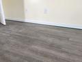 Uneven wood floors with laser level on basebaord