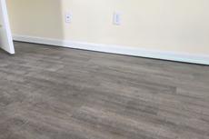 Uneven wood floors with laser level on basebaord